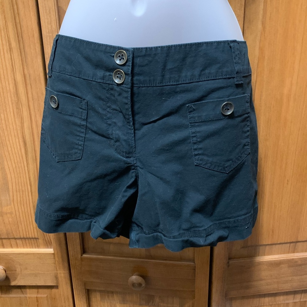 Black booty shorts with buttons. Small pockets